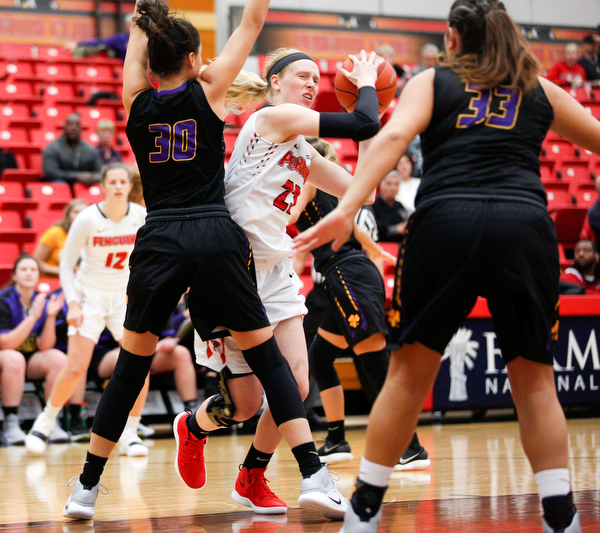 YSU's Sarah Cash tries to get the ball past Carlow's Emma Stille (30) and Bria Rathway (33) during their game Friday night at YSU. EMILY MATTHEWS | THE VINDICATOR