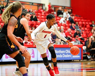 YSU's Amara Chikwe dribbles the ball to try to keep it away from Carlow's Bria Rathway, center, and Delaney Daly, left, during their game Friday night at YSU. EMILY MATTHEWS | THE VINDICATOR