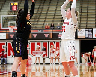 YSU's McKenah Peters looks to pass the ball as Carlow's Emily Grandy tries to block her during their game Friday night at YSU. EMILY MATTHEWS | THE VINDICATOR