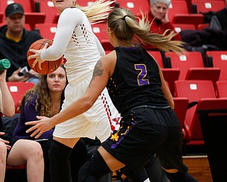 YSU's Alison Smolinski looks to pass the ball as Carlow's Delaney Daly tries to block her during their game Friday night at YSU. EMILY MATTHEWS | THE VINDICATOR