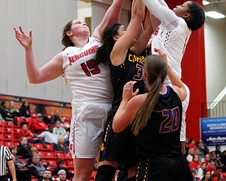 YSU's Mary Dunn, left, and Amara Chikwe work to get the ball into the basket as Carlow tries to block and get to the ball during their game Friday night at YSU. EMILY MATTHEWS | THE VINDICATOR