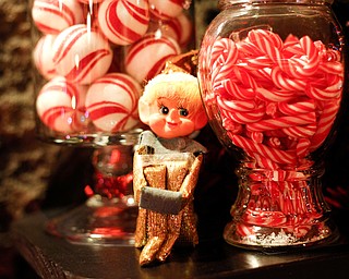 An elf sits among candy canes and peppermints in the Memories of Christmas Past exhibition at The Arms Family Museum on Saturday. EMILY MATTHEWS | THE VINDICATOR