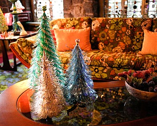 Tinsel Christmas trees are displayed in a living room in the Memories of Christmas Past exhibition at The Arms Family Museum on Saturday. EMILY MATTHEWS | THE VINDICATOR