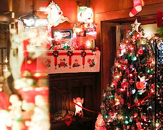 A Christmas tree and decorations are displayed in the Memories of Christmas Past exhibition at The Arms Family Museum on Saturday. EMILY MATTHEWS | THE VINDICATOR