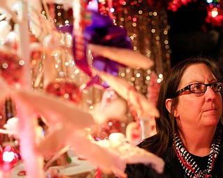 Barbara Robeson, of Youngstown, looks at decorations on display in the Memories of Christmas Past exhibition at The Arms Family Museum on Saturday. EMILY MATTHEWS | THE VINDICATOR