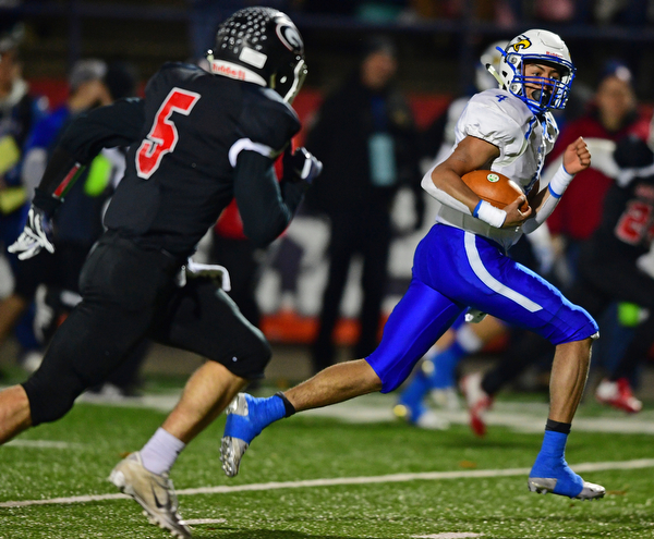 NILEs, OHIO - NOVEMBER 17, 2018: Hubbard's Davion Daniels runs away from Girard's Nick Malito and into the end zone to score a touchdown during the first half of the OHSAA Division 4 Region 13 Regional Final game, Saturday night at Niles McKinley High School. DAVID DERMER | THE VINDICATOR