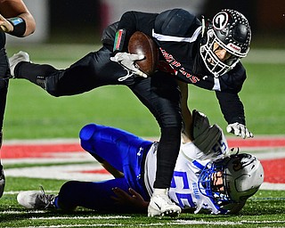 NILEs, OHIO - NOVEMBER 17, 2018: Girard's Morgan Clardy fights off a tackle from Hubbard's Mark Jones during the first half of the OHSAA Division 4 Region 13 Regional Final game, Saturday night at Niles McKinley High School. DAVID DERMER | THE VINDICATOR