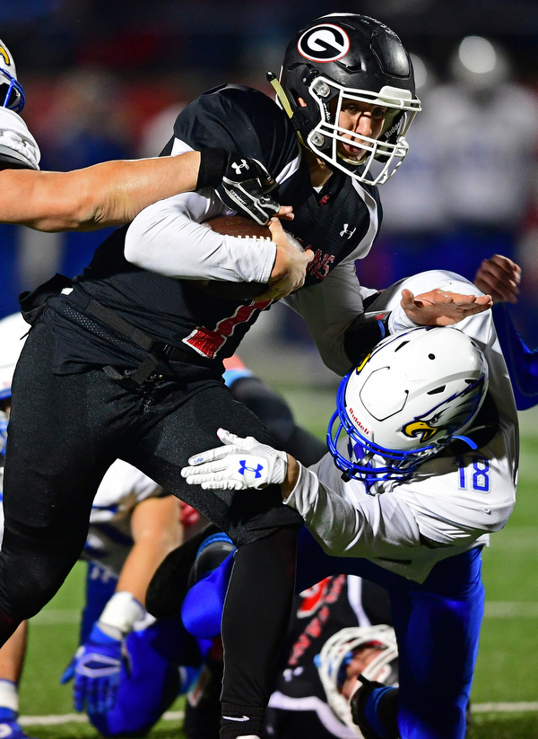 NILEs, OHIO - NOVEMBER 17, 2018: Girard's Mark Waid runs through Hubbard's Kobe Krisuk during the first half of the OHSAA Division 4 Region 13 Regional Final game, Saturday night at Niles McKinley High School. DAVID DERMER | THE VINDICATOR