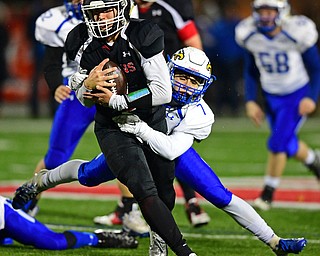 NILEs, OHIO - NOVEMBER 17, 2018: Girard's Mark Waid is tackled by Hubbard's Cam Resatar  during the second half of the OHSAA Division 4 Region 13 Regional Final game, Saturday night at Niles McKinley High School. DAVID DERMER | THE VINDICATOR