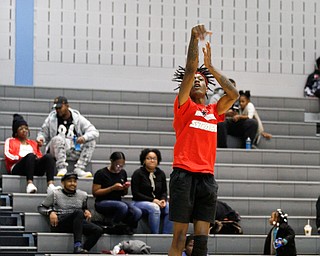 Local artist JonezyTooCool shoots the ball while warming up for the Rising Stars basketball game at East High School on Sunday. EMILY MATTHEWS | THE VINDICATOR