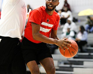 Local theater actor James Major Burns looks to pass the ball as local artist Lester Scott attempts to block him during the Rising Stars basketball game at East High School on Sunday. EMILY MATTHEWS | THE VINDICATOR