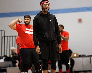 Campbell High School alumnus Anthony Moses cheers while local artist Jay King reacts after the red team scores during the Rising Stars basketball game at East High School on Sunday. After the Rising Stars game, Moses played in the Campbell vs. Youngstown alumni game. EMILY MATTHEWS | THE VINDICATOR