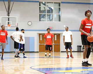 Local artist JonezyTooCool shoots a foul shot during the Rising Stars basketball game at East High School on Sunday. EMILY MATTHEWS | THE VINDICATOR