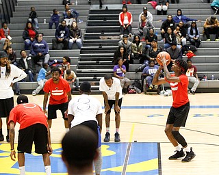 Local artist JonezyTooCool prepares to shoot during the Rising Stars basketball game at East High School on Sunday. EMILY MATTHEWS | THE VINDICATOR