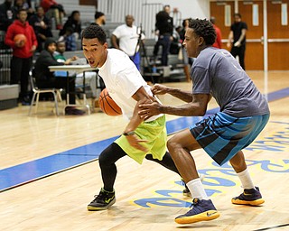 Campbell alumnus Terrance Phillips, left, tries to keep the ball away from Youngstown alumnus Charles Thomas during the Youngstown vs. Campbell alumni basketball game at East High School on Sunday. EMILY MATTHEWS | THE VINDICATOR