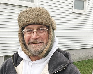 Kenneth York stands near the back door of his Hall Street Northwest home in Warren, describing how a man broke out a piece of glass in the back door and came through the back door at 1 a.m. Tuesday. York was on the other side pointing a gun at the suspect, later identified as Billy R. Morrow Sr.