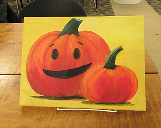 Neighbors | Jessica Harker.Librarian Andrea Zupcsan pre-painted a halloween themed painting for her Art with Andrea class at the Austintown library.