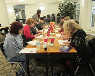 Neighbors | Jessica Harker.Community members gathered at the Austintown library to paint a Halloween painting for the Art with Andrea event on Oct. 23.