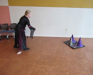 Neighbors | Jessica Harker.Journey Sherl played witch's hat ring toss at the Michael Kusalaba library's first Halloween celebration on Oct. 29.