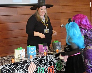 Neighbors | Jessica Harker.Librarian assistant Amelia Dale helped children gathered at the Michael Kusalaba library for the Monster Mash Halloween Party figure out what Halloween themed food was in each box.