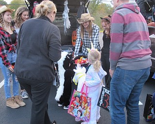 Neighbors | Jessica Harker.Children dressed in costumes attended Poland Seminary High School's Trunk or Treat event to get candy from high school students who decorated their trunks for the event.