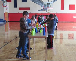 Neighbors | Jessica Harker.Four tables were set up in the Austintown Intermediate School gymnasium for students to practice cup stacking during their gym period.