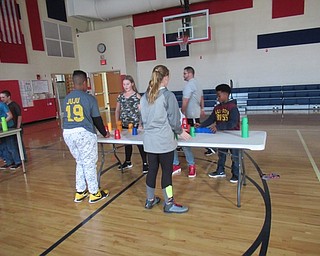 Neighbors | Jessica Harker.Gym teacher Jason Stroh helped students practice their 3-3-3 stacks on Nov. 7 during gym class at Austintown Intermediate School.