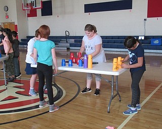 Neighbors | Jessica Harker.Students stood at tables practicing cup stacking during their gym class run by teacher Jason Stroh on Nov. 7.