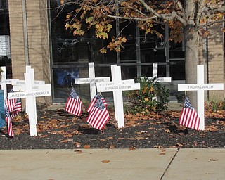 Neighbors | Jessica Harker.Students Serving Veterans volunteers placed 17 crosses made by Jim O'Neil in front of Austintown Fitch High School commemorating every Fitch student who has been killed in combat.
