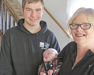 Angie Vint holds her grandson, Daniel Dutting, as she stands next to her son, James Vint Jr.,  the baby’s father. Despite all the tragedies the family faced in the past year, Angie Vint remains thankful for her children, her new grandson and their new home. The family moved into the house where her late husband James Vint’s parents lived, and Angie is in the process of buying the house.