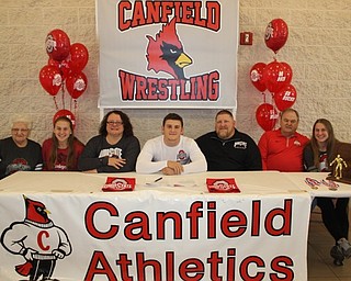 Neighbors | Abby Slanker.Canfield High School senior wrestler Tyler Stein (center) signed his National Letter of Intent to continue his academic and wrestling career at The Ohio State University at a signing ceremony at the high school on Nov. 14. Joining him was his family, from left, Rose McAtee, Ally Stein, Tracey Stein, Doug Stein, Charles McAtee and Hannah Stein.