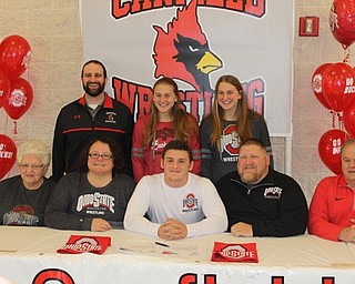 Neighbors | Abby Slanker.Canfield High School head wrestling coach Steve Pitts (back, left) celebrated senior wrestler Tyler Stein (center) signing his National Letter of Intent to continue his academic and wrestling career at The Ohio State University at a signing ceremony at the high school. Joining them was Stein’s family.