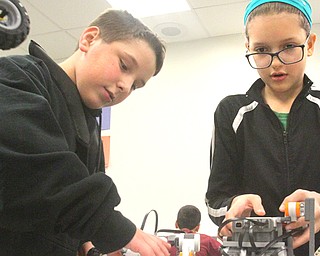Zaiden Husk, left, and Meadow Smith, both Liberty seventh-graders, control their robots during robotics class. This is the first year for robotics and some other science, technology, engineering and mathematics program in the Liberty schools.