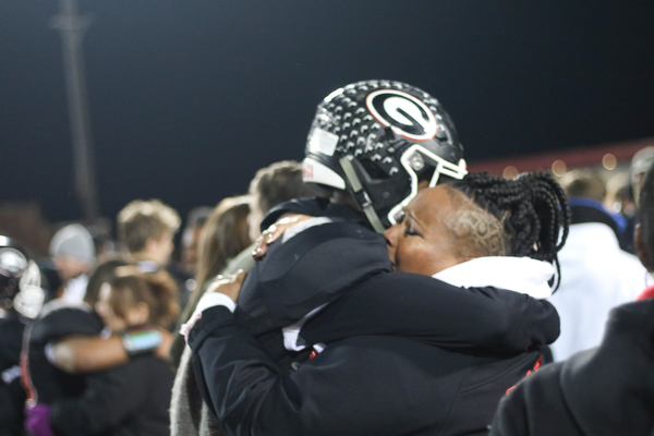 Girards Jimmy Jones embraces a Girard fan after state semi final win in Dover, Ohio on Saturday Nov. 24, 2018. ETHAN CLEWELL | THE VINDICATOR