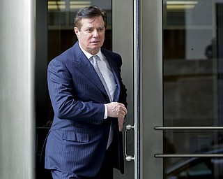 In this Feb. 14, 2018 file photo, Paul Manafort, President Donald Trump's former campaign chairman, leaves the federal courthouse in Washington. Manafort says in a statement that a Guardian report saying he met with Assange at the Ecuadorian embassy is "totally false and deliberately libelous." Manafort says that he has never been contacted by "anyone connected to WikiLeaks, either directly or indirectly. 