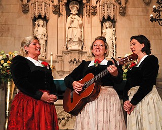 The Kroell Family Singers, Gerlinde, left, Elisabeth, center, and Christiane, sing Christmas Carols during a celebration of the song "Silent Night," at Trinity Church, Tuesday, Nov. 27, 2018, in New York. "Silent Night," one of the most famous songs of the Christmas season, is being celebrated as it approaches its 200th anniversary. Written and sung in Austria in December 1818, the song was first performed in the U.S. in 1839 at the Hamilton Memorial on the church's grounds by an Austrian family of traveling singers. 