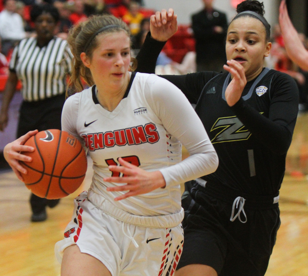 William D. Lewis The Vindicator YSU's Chelsea Olson(12) drives around Akron's Kendall Miller(1).
