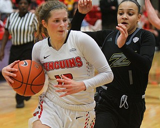 William D. Lewis The Vindicator YSU's Chelsea Olson(12) drives around Akron's Kendall Miller(1).