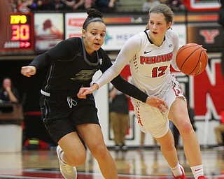 William D. Lewis The Vindicator YSU's Chelsea Olson(12) drives around Akron's Kendal Miller(1).