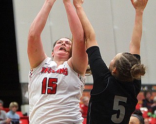 William D. Lewis The Vindicator YSU'sMary Dunn(15) ) shoots around Akron's Haliegh Reinoehl(5).