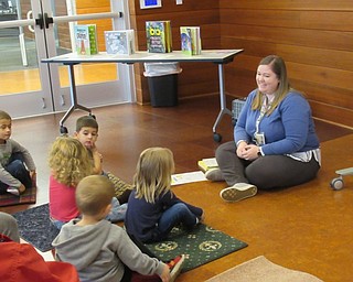 Neighbors | Jessica Harker.Children gathered for the Read and Make event at the Michael Kusalaba library where they sat with librarian assistant Amelia Dale to read books and sing songs before participating in a craft.