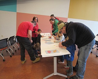 Neighbors | Jessica Harker.Children used candy wrappers to make a mosaic of paper leaves during the candy themed Read and Make event hosted on Nov. 1.
