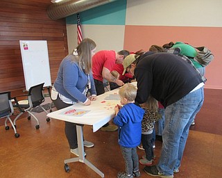 Neighbors | Jessica Harker.Children and parents who attended the Read and Make event at the Michael Kusalaba library used candy wrappers to decorate paper leaves Nov. 1.