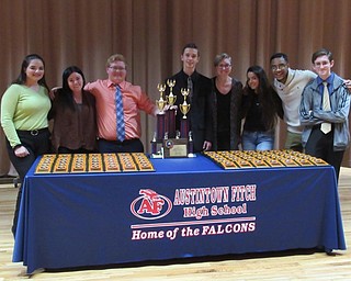 Neighbors | Jessica Harker .Student members of the Austintown speech and debate team posed around trophys Nov. 16 while decorating the school for the tournament.