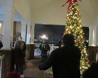 Neighbors | Jessica Harker.Residents of the Inn at Walker Way and their families gathered outside at the buildings Christmas tree for the official tree lighting.