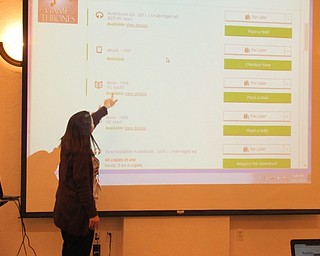 Neighbors | Jessica Harker.Renee Beverly, an Austintown librarian, showed community members gathered how to use the updated library system Nov. 12.
