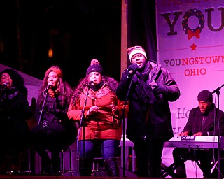 Josh Triplett performs before Youngstown's annual Holiday Parade on Friday night. EMILY MATTHEWS | THE VINDICATOR