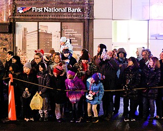 People watch as Youngstown's annual Holiday Parade begins on Friday night. EMILY MATTHEWS | THE VINDICATOR