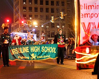 The Ursuline High School Fighting Irish Band marches behind the YWCA in Youngstown's annual Holiday Parade on Friday night. EMILY MATTHEWS | THE VINDICATOR