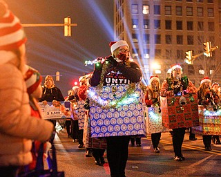 Members of the Crestview Rebels Marching Band perform while being dressed as Christmas presents during Youngstown's annual Holiday Parade on Friday night. EMILY MATTHEWS | THE VINDICATOR